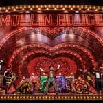 Cameron Blakely as Harold Zidler and the original world tour company of MOULIN ROUGE! THE MUSICAL